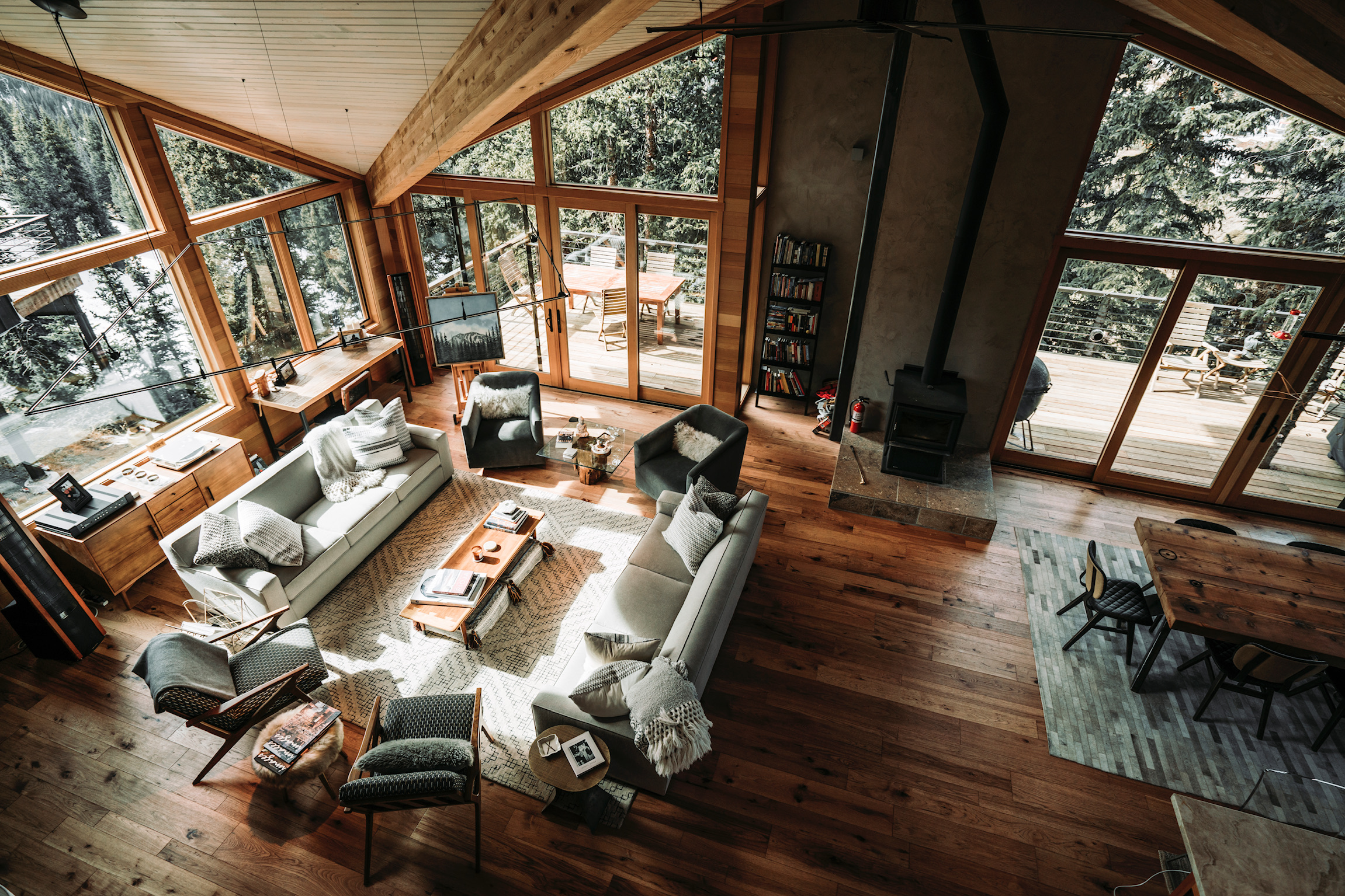 Mountain home interior showing timber framing and large windows with mountain views